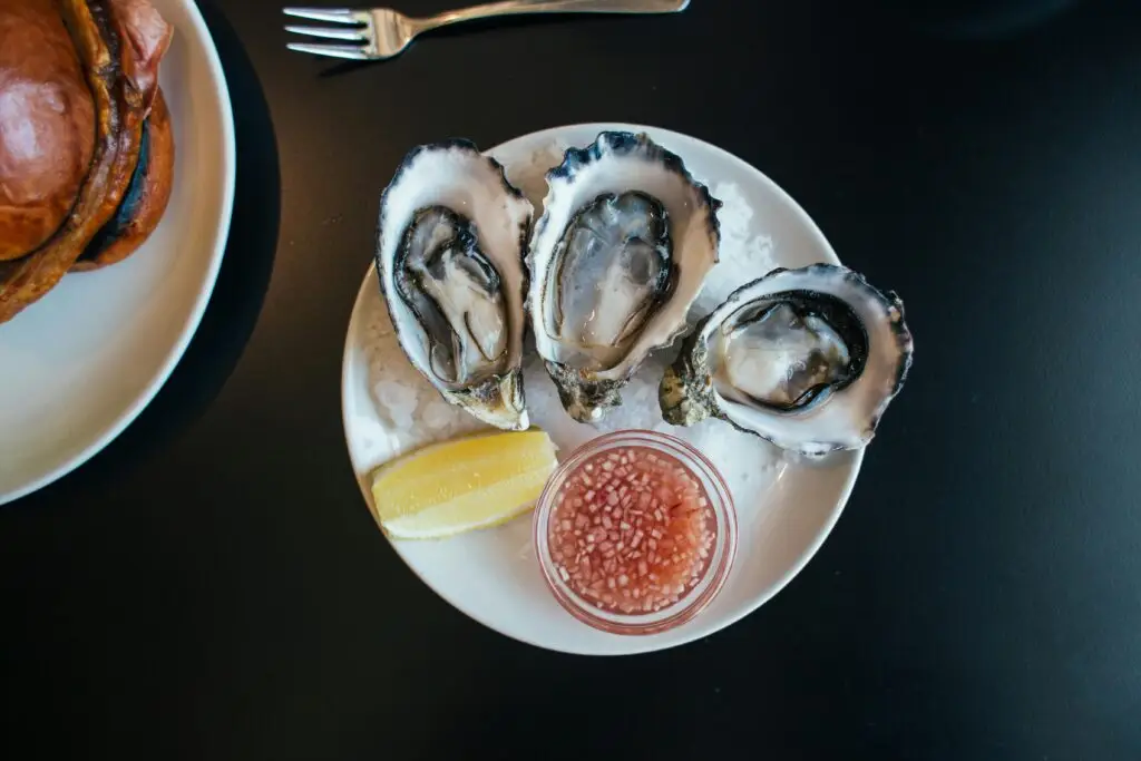 Seafood dish of Oysters served on plate garnish and lemon