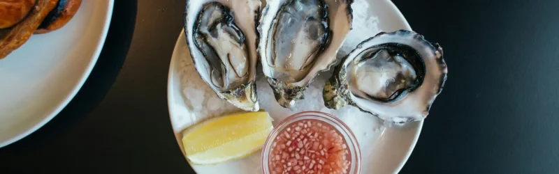 Seafood dish of Oysters served on plate garnish and lemon